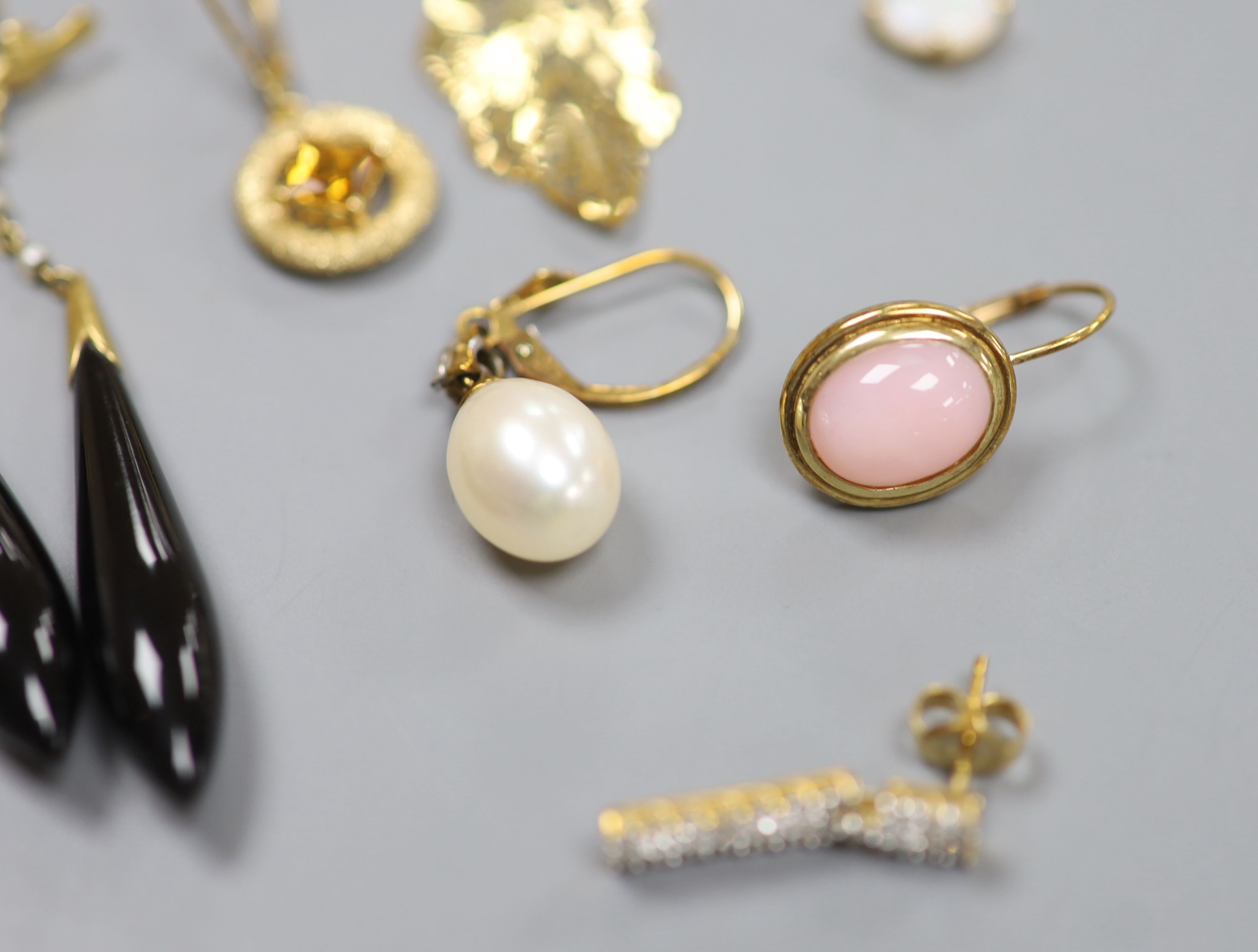 Seven pairs of hallmarked gold earrings, variously set, a single 14K marked stud earring, a pair of drop earrings and a yellow metal ring